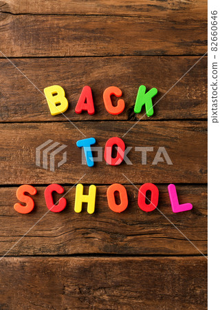 Back to school. Overhead shot of colourful text on vintage wooden background Back to school. Overhead shot of colourful text on vintage wooden background 82660646