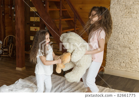 A beautiful girls with Teddy bear, a child with toy. The concept of childhood, morning pastime 82661775