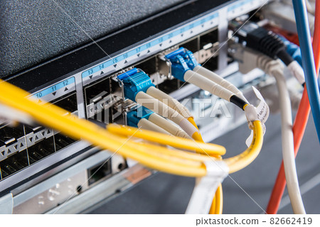 Fiber Optic cables connected to an optic ports 82662419