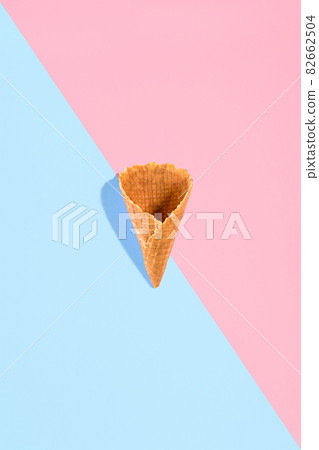Sugar waffle cone for ice cream arranged in pattern on pink and mint background. The image with copy space can be used as a background for the design of the confectionery menu 82662504
