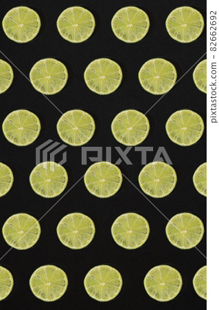 Lime pattern on black background. Minimal flat lay concept. Lime pattern on black background. Minimal flat lay concept. 82662692