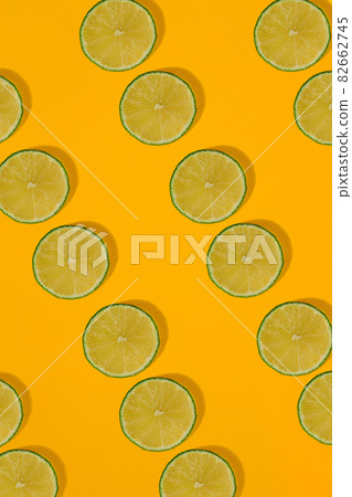 Lime pattern on yellow background. Minimal flat lay concept. Lime pattern on yellow background. Minimal flat lay concept. 82662745