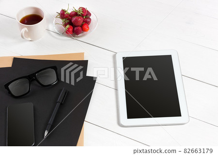 Tablet, blank sheet, glasses and coffee cup on office wooden table 82663179