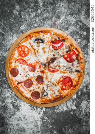 Slices of italian pizza on abstract dark background with wheat flour. Slices of italian pizza on abstract dark background with wheat flour. 82663543
