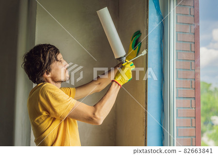 Builder or handyman is engaged in the repair or installation of windows Builder or handyman is engaged in the repair or installation of windows 82663841