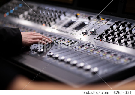sound engineer working with audio mixing console 82664331