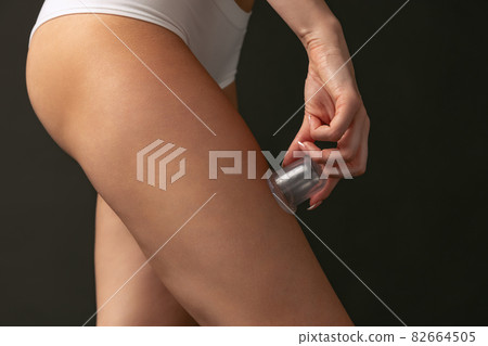 Beautiful female hips and legs isolated on dark studio background. Natural beauty, spa, anti-cellulite treatments concept. 82664505