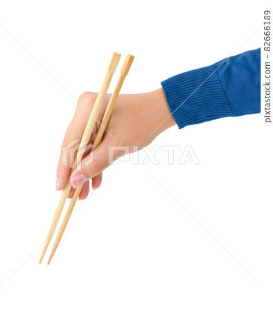 Hand with chopsticks Hand with chopsticks 82666189