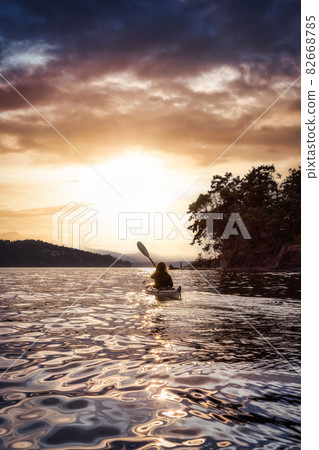 Adventurous Woman on Sea Kayak paddling in the Pacific Ocean. 82668785