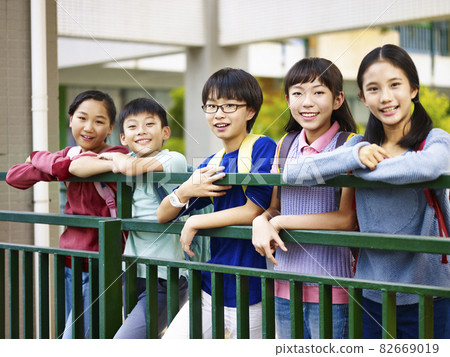 portrait of a group of happy and smiling elementary school students 82669019