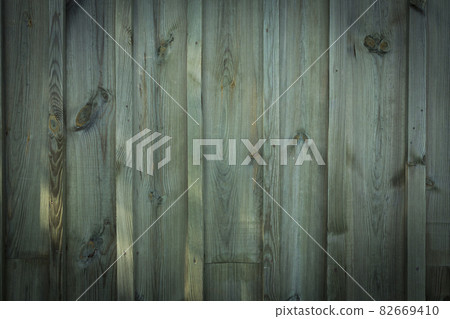 Wooden logs of an old house. Close-up. Weathered green wood texture. Background. Horizontal vertical photo. Wooden logs of an old house. Close-up. Weathered green wood texture. Background. Horizontal vertical photo. 82669410