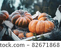 Bright orange Halloween pumpkins in a wooden crate 82671868
