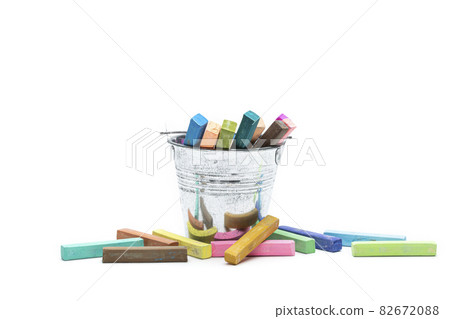 Square colorful pastel chalks is placed in a tin can and on a white background. Square colorful pastel chalks is placed in a tin can and on a white background. 82672088