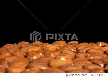 Fresh almond on black glass 82673452