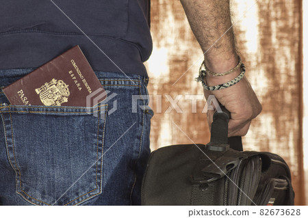man with suitcase and passport in pocket man with suitcase and passport in pocket 82673628