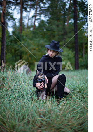 Woman with blonde hair with trees behind Woman with blonde hair with trees behind 82675849