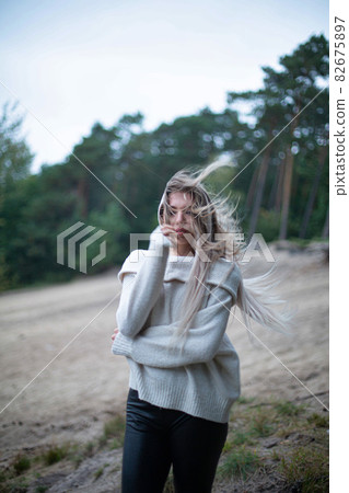 Woman in forest with trees behind 82675897