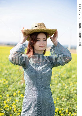 Girl with dark hair in blooming field 82676433