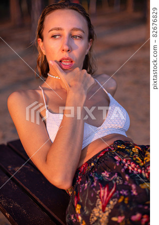Girl with blonde hair with sand on background Girl with blonde hair with sand on background 82676829