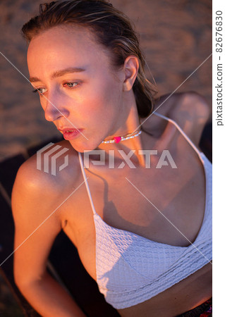 Girl with blonde hair with sand on background Girl with blonde hair with sand on background 82676830