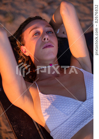 Girl with blonde hair with sand on background Girl with blonde hair with sand on background 82676832