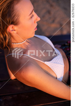 Girl with blonde hair with sand on background Girl with blonde hair with sand on background 82676833
