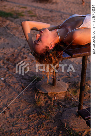 Girl with blonde hair with sand on background Girl with blonde hair with sand on background 82676834