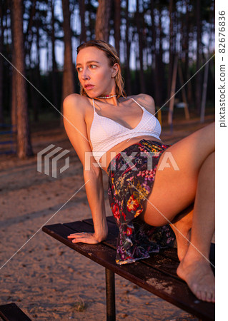 Girl with blonde hair with trees behind Girl with blonde hair with trees behind 82676836
