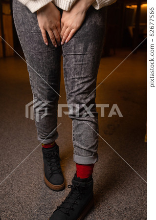 Low Section View Of Person's Wet Jeans Standing On Carpet. 82677566