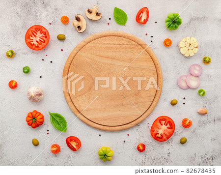 The ingredients for homemade pizza set up on white concrete background. The ingredients for homemade pizza set up on white concrete background. 82678435
