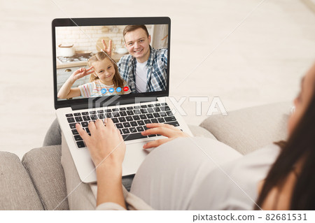 Pregnant Lady Videochatting With Husband And Little Daughter On Laptop At Home Pregnant Lady Videochatting With Husband And Little Daughter On Laptop At Home 82681531
