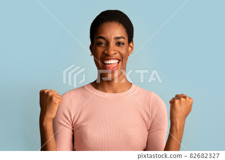Big Luck. Overjoyed Black Woman Raising Fists And Exclaiming With Excitement 82682327