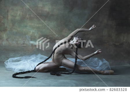 Portrait of young professional ballet dancer, attractive ballerina dancing isolated over dark retro background Portrait of young professional ballet dancer, attractive ballerina dancing isolated over dark retro background 82683328