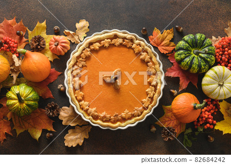 Homemade tasty pumpkin pie with autumn decorations and leaves for Thanksgiving Day on white. Homemade tasty pumpkin pie with autumn decorations and leaves for Thanksgiving Day on white. 82684242