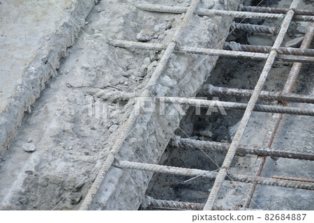 SERDANG, MALAYSIA -JUNE 03, 2016: Concrete construction joint at the construction site. Wire mesh used to join cast concrete and the new concrete. The join needs to do carefully to avoid leakage. SERDANG, MALAYSIA -JUNE 03, 2016: Concrete construction joint at the construction site. Wire mesh used to join cast concrete and the new concrete. The join needs to do carefully to avoid leakage. 82684887