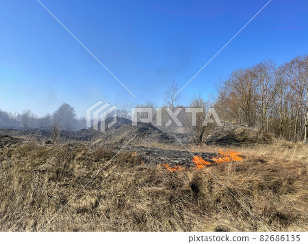 Fire in the field in farmland 82686135