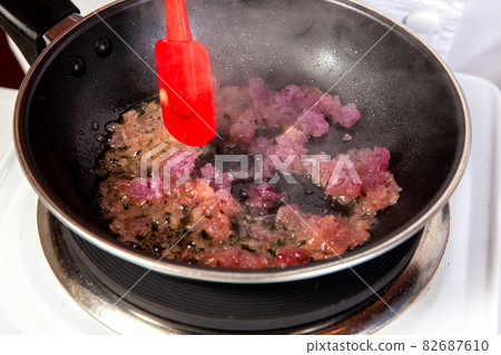Preparation of a traditional Colombian fried  stuffed yucca dumplings called carimanolas 82687610