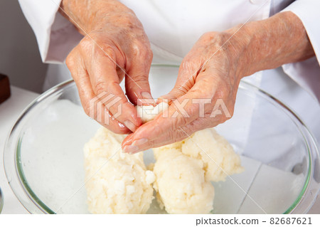 Preparation of a traditional Colombian fried stuffed yucca dumplings called carimanolas Preparation of a traditional Colombian fried stuffed yucca dumplings called carimanolas 82687621