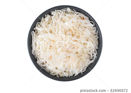Sauerkraut on a white background. Pickled cabbage close-up in a plate on a white background. Sauerkraut on a white background. Pickled cabbage close-up in a plate on a white background. 82690872