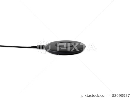 Wireless charging for a smartphone on a white background. Fast wireless charger close-up. Wireless charging for a smartphone on a white background. Fast wireless charger close-up. 82690927
