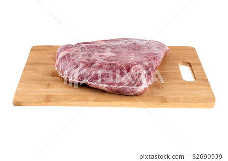 Vacuum packed meat on a white background. Beef in a vacuum bag on a board close-up. 82690939