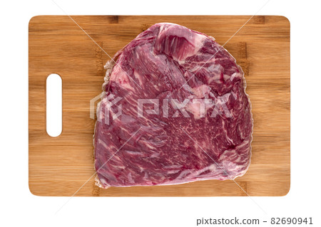 Vacuum packed meat on a white background. Beef in a vacuum bag on a board close-up. 82690941