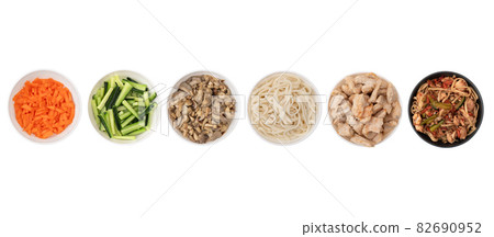 Asian wok noodles on white background. Wok noodles close-up, top view. A set of products for making wok noodles. Asian wok noodles on white background. Wok noodles close-up, top view. A set of products for making wok noodles. 82690952