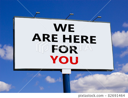 Support symbol. Words 'we are here for you' on white billboard. Beautiful blue sky. Business and support concept. Copy space. Support symbol. Words 'we are here for you' on white billboard. Beautiful blue sky. Business and support concept. Copy space. 82691464