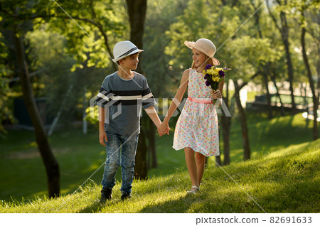 Children's date, boy and girl with bouquet Children's date, boy and girl with bouquet 82691633