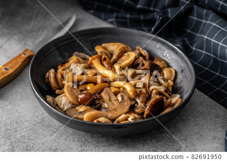 Sliced preserved mushrooms in bowl. Sliced preserved mushrooms in bowl. 82691950