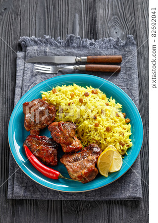 roasted meat served with raisins saffron rice 82692041