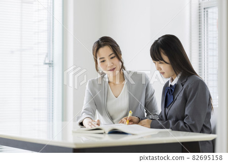 Female students receiving individual guidance at a cram school High school students Junior high school students Female students receiving individual guidance at a cram school High school students Junior high school students 82695158