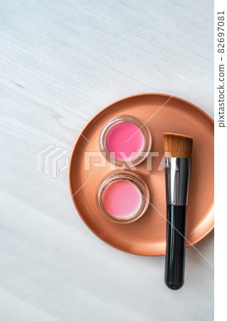 Makeup brush with blush pink and rouge color cream jars palette on stainless steel mixing plate - Make-up professional tool for artist. Top view background Makeup brush with blush pink and rouge color cream jars palette on stainless steel mixing plate - Make-up professional tool for artist. Top view background 82697081