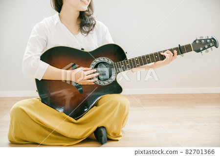 Woman playing the guitar Woman playing the guitar People playing the guitar in the room Woman playing the guitar Woman playing the guitar People playing the guitar in the room 82701366